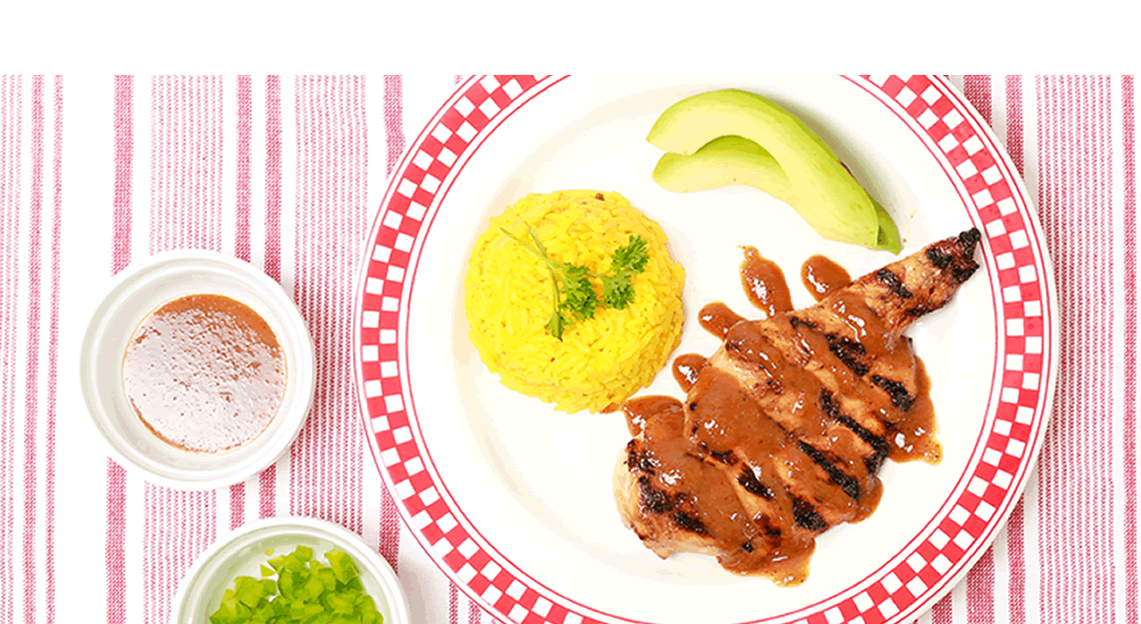 Redi Fredi traditional dish with yellow rice and avocado slices.